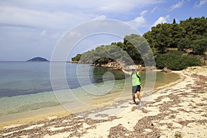 Tourists men on Aegean coast of Sithonia peninsula