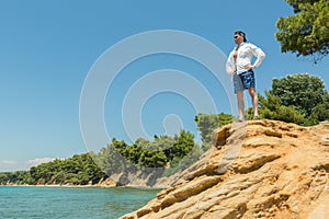 Tourists men on Aegean coast of Sithonia peninsula