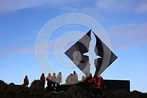 Tourists at the monument on Hornos Island. Cape Horn. Chile