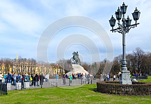 Tourists at monument to Peter Great Bronze Horseman on Senate Square, St. Petersburg, Russia