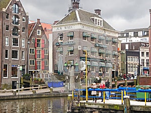 Tourists on a mooring of pleasure boats in Amsterdam . Netherla