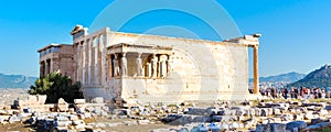 Tourists near Erechtheum temple ruins in Acropolis, Athens banner background