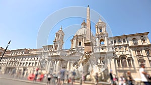 Tourists near Fountain of the Four Rivers on Piazza Navona in Rome Italy