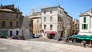 Tourists near gift shops on square in Arles