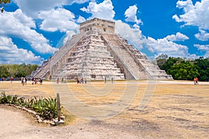 Tourists next to the Pyramid of Kukulkan at Chichen Itza in Mexico