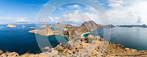 Tourists observing the Panoramic view from the top of Padar Island in Komodo National park, Lubuan Bajo, Indonesia photo