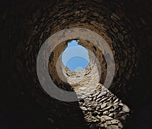 tourists at the old castle fell into the famine. the view from the well up to