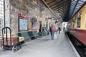 Tourists on old heritage vintage railway station platform with carriages