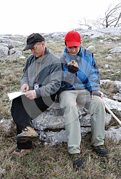 Tourists orienteering by map and GPS.