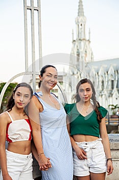 Tourists at the Ortiz Bridge with La Ermita church on background in the city of Cali in Colombia photo