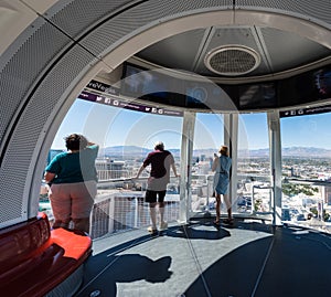 Tourists overlooking the Las Vegas Strip on the High Roller Ferris Wheel