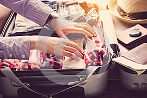 Tourists are packing luggage for travel.