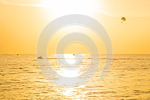 Tourists para-sailing in sunset time at Phuket Beach, Thailand