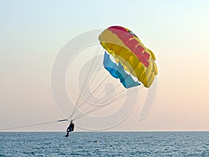 Tourists with parachute above the sea