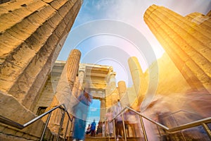 Tourists pass through the Propylaea entrance to the Parthenon, motion blur