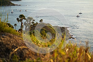 Tourists at Phromthep cape viewpoint at the south of Phuket Island, Thailand. Tropical paradise in Thailand. Phuket is a popular