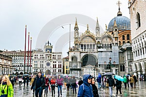 Tourists in Piazza San Marco St Marks Square. San Marco Basilica Patriarchal Cathedral of Saint Mark in Venice, Italy