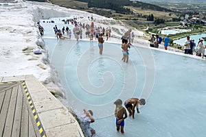 Tourists play in one of the thermal pools at Cotton Castle in Turkey.