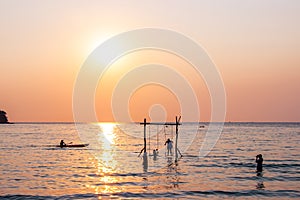 Tourists play in the water sea during the sunset at area ao bang bao Koh kood island Trat, Thailand