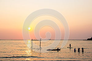 Tourists play in the water sea during the sunset at area ao bang bao Koh kood island Trat, Thailand