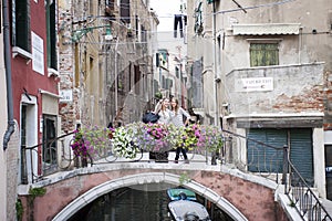 Tourists at Ponte de la Chiesa, Venice, Italy