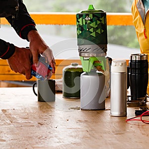 Tourists prepare coffee using gas cylinders.