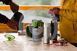 Tourists prepare coffee using gas cylinders.