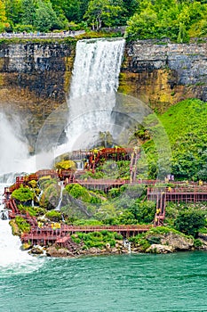 Tourists in raincoats on the Cave of the Winds Lookout, stairs and platforms, wooden walkways, ponchos for an up-close