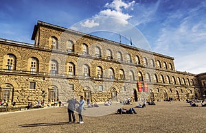 Tourists relax on the square in front of Palazzo Pitti, Florence,