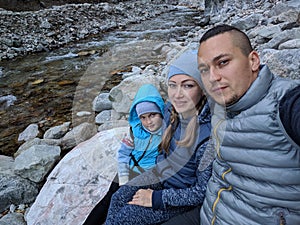 Tourists rest after hike and take selfie on the phone. Photos from the phone during the hike. Family travels. People