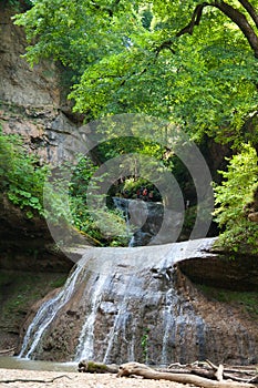 Tourists rest on the top of a waterfall