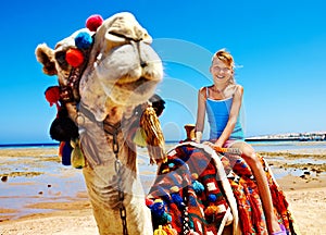 Tourists riding camel on the beach of Egypt.