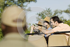 Tourists On Safari Pointing At View