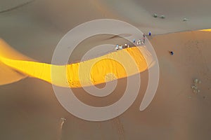 Tourists in the Sahara Desert on sandboarding