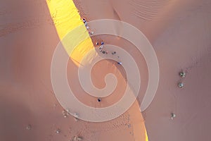 Tourists in the Sahara Desert on sandboarding