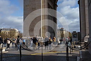 Tourists and school children underneath the Arc de Triomphe on a spring morning in Paris, France