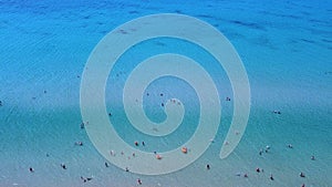 Tourists in the sea. People swimming and relaxing in the sea on weekend. Aerial view