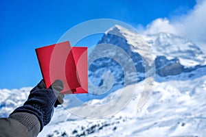 Tourists see beautiful viewpoitn near Kleine Scheidegg station and showing red card and snow mountain background