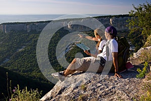 Tourists sitting on mountain