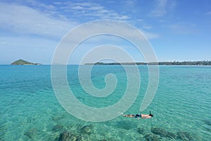 Tourists snorkel in crystal turquoise water near tropical resort in Phuket, Thailand. Summer, Vacation, Travel and Holiday concept