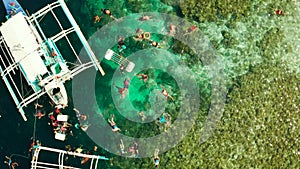 Tourists snorkelling in coral reef, Moalboal, Philippines