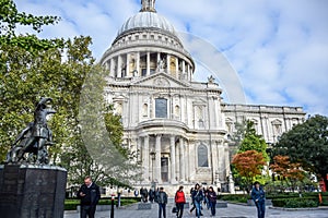 Tourists spending their time at St Paul`s Cathedral facade in London, England, United Kingdom