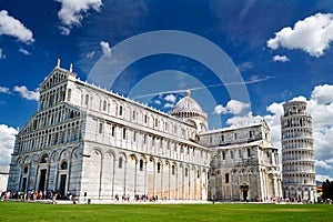 Tourists on Square of Miracles visiting Leaning Tower in Pisa, Italy.