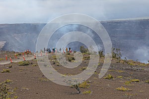 Tourists watch the lava flow inside Hawai'i Volcanoes National