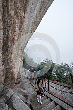 Tourists on steep mountain trail in Huashan mountain