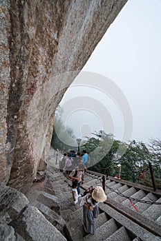 Tourists on steep mountain trail in Huashan mountain