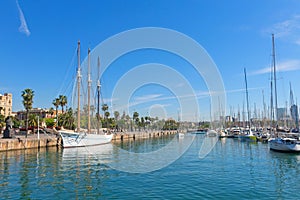 Tourists stroll along the port next to Santa Eulalia in Barcelona, Spain photo