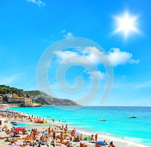 Tourists, sunbeds and umbrellas on hot day. Travel background