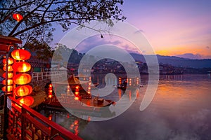 Tourists take a boat on lake at Ban Rak Thai village in morning , Mae Hong Son province, Thailand. Yunnan Chinese community