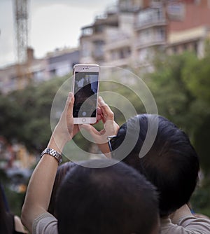 Tourists take phone photo La Sagrada Familia photo